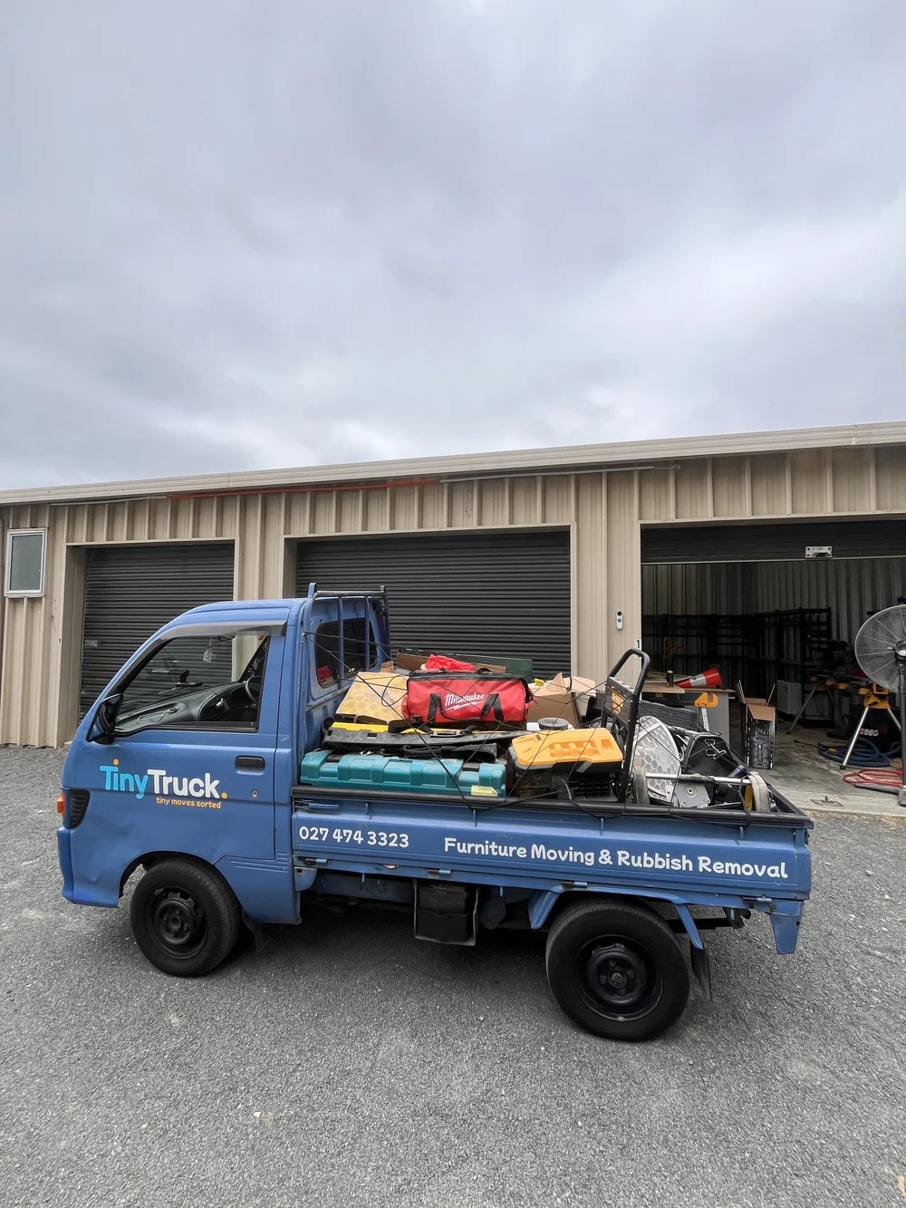 Tiny Truck packed with power tools, tool bags and a hand trolley for a workshop move