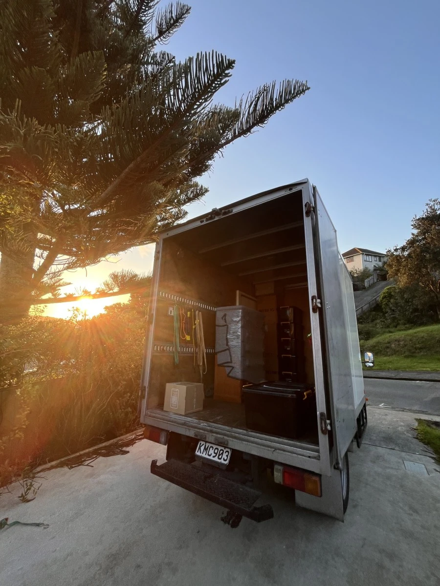 Tiny Truck's new box truck at sunset with furniture and boxes loaded for a house move