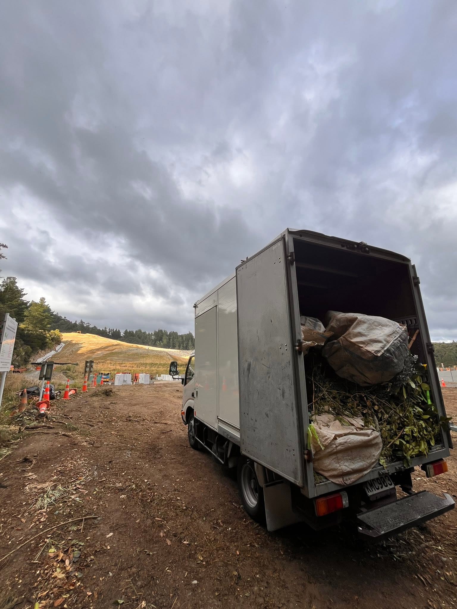 Tiny Truck's new box truck loaded with green waste bags and branches at the tip