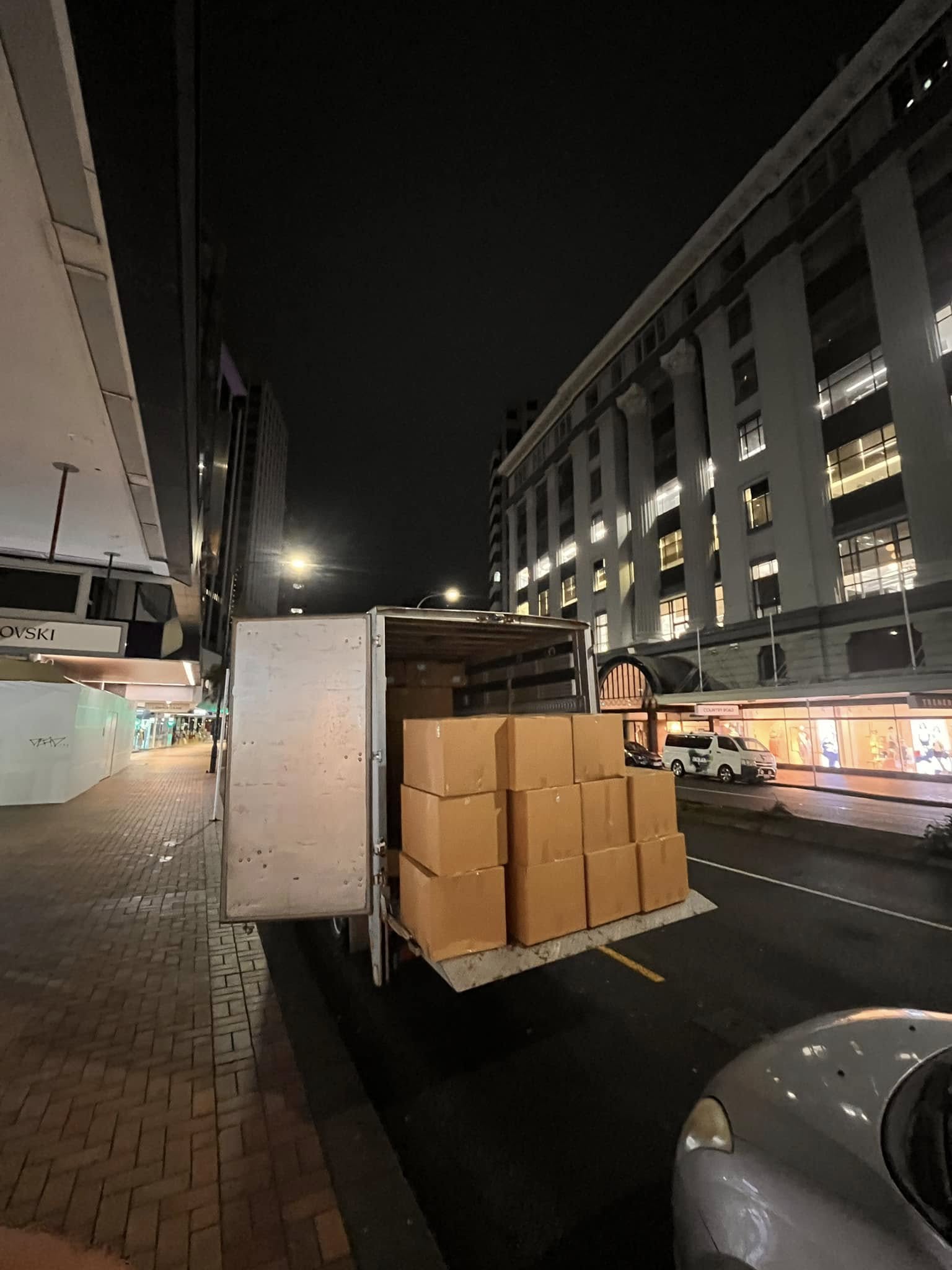 Tiny Truck box truck tail lift stacked with cartons for a night delivery in central Wellington