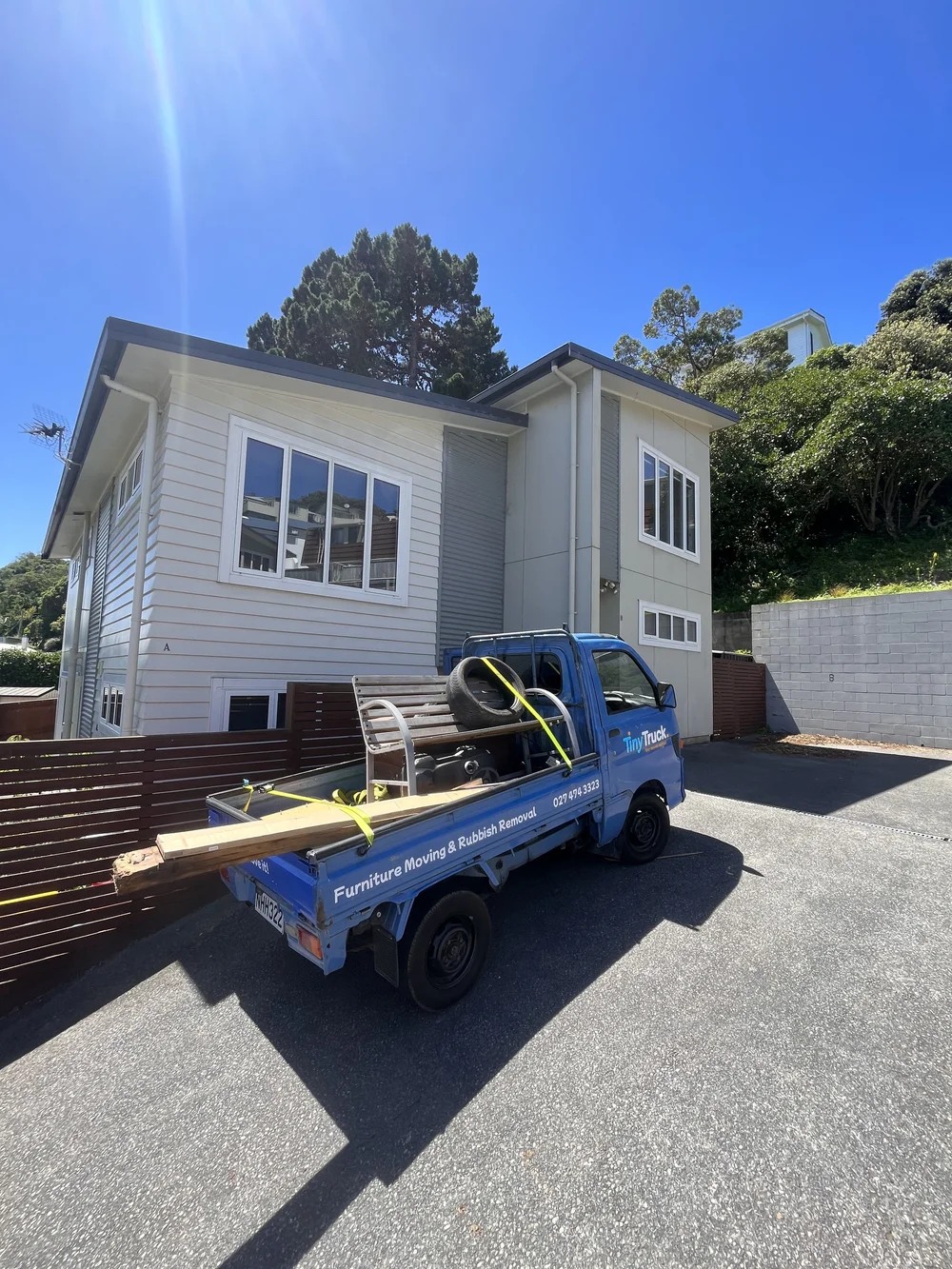 Tiny Truck loaded with an old bench, tyre, timber and scrap for a rubbish removal job